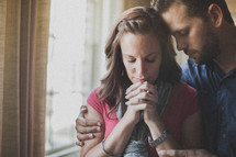 husband and wife praying together 