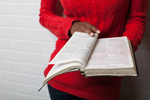 torso of an African-American woman reading a Bible 
