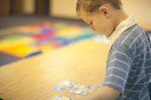 child playing with a board game 
