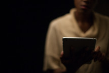 African-American woman looking at an iPad screen 