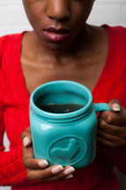 African-American woman holding a mug 