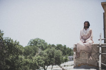 Jesus sitting on a roof
