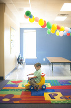 toddler boy playing in a church nursery 