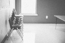 stacked chairs in an empty classroom
