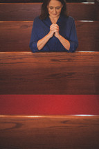 woman praying in a church 