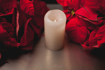 red poinsettia and candle 