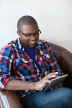 African-American looking at an iPad screen 