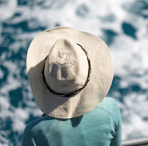 woman on a boat in a sunhat 