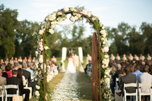 an arch an alise at a wedding ceremony 