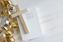 gold streamers and Bible on a white background
