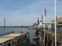 DUESSELDORF, GERMANY - CIRCA AUGUST 2019: People on Rheinuferpromenade on the bank of river Rhein in the Altstadt (old town)