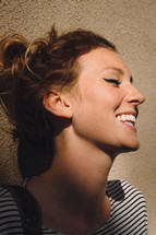 smiling face of a young woman with closed eyes 