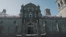 Dolly pov showing entrance of historic Nuestra Senora Cathedral during sunny day in Puebla,Mexico	