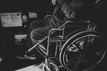 a man in a wheelchair on a city bus 