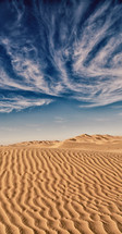 wispy clouds over the desert in Oman 