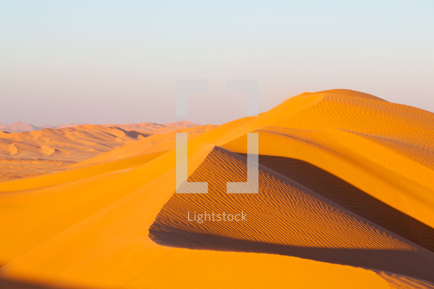golden sand dunes in a desert in Oman 