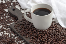 coffee and coffee beans on cutting board 