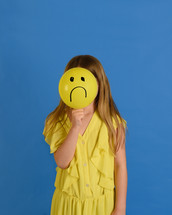 sad child in yellow dress 