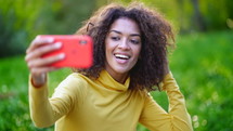 Smiling Happy African American Woman With Curly Hair In Yellow Making Selfie