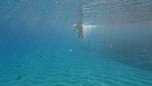Boy swimming in shallow ocean water