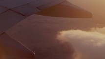 Engine on airplane wing at sunset