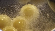 Boiling vegan agnolotti with vegetables filling traditional Italian pasta food