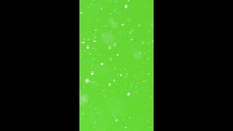 Vertical video of snow in green screen background, It is snowing overlay
