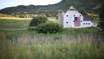American flag hanging on a barn