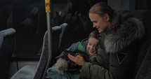 Child and mother traveling by bus