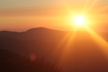 sunburst over a mountain range