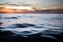 dark ocean water at sunset 