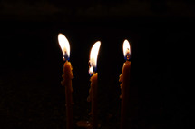 three candles melting wax 