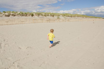 Boy running on the beach.