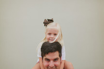 a daughter on her father's shoulders