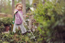 girl child watering a garden 