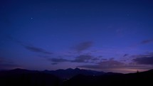 Silhouette of a mountain landscape under the night sky at dusk, the first stars in the sky