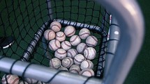 baseballs in a net basket 