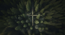 Forrest from an aerial perspective showing a cross amongst the trees
