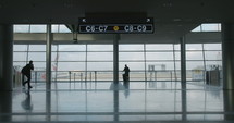 silhouette of People in airport terminal walking with luggage
