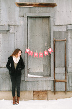 a girl standing near a love banner 