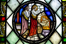 stained glass window of Jesus healing 