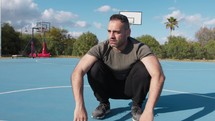 Man Does Push Ups Burpees With Jump In Blue Basketball Court Outdoors