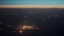 Aerial view of city lights at sunrise