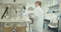 Female lab technician working in a pharmaceutical laboratory conducting experiments