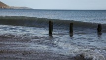 Slow Motion of Wave Crashing Over Old Breakwater on Youghal Beach, County Waterford, Ireland
