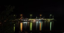 Timelapse of quay with boats at night, Greece