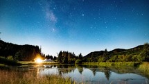 stars in the night sky over a campsite 