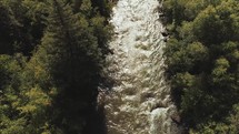 aerial view of a river through a forest in summer 