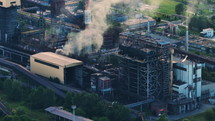 Aerial view of coal power plant high pipes with black smoke moving up polluting atmosphere. 