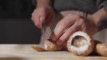 Female Hands Cutting Mushrooms Using A Knife - Close Up